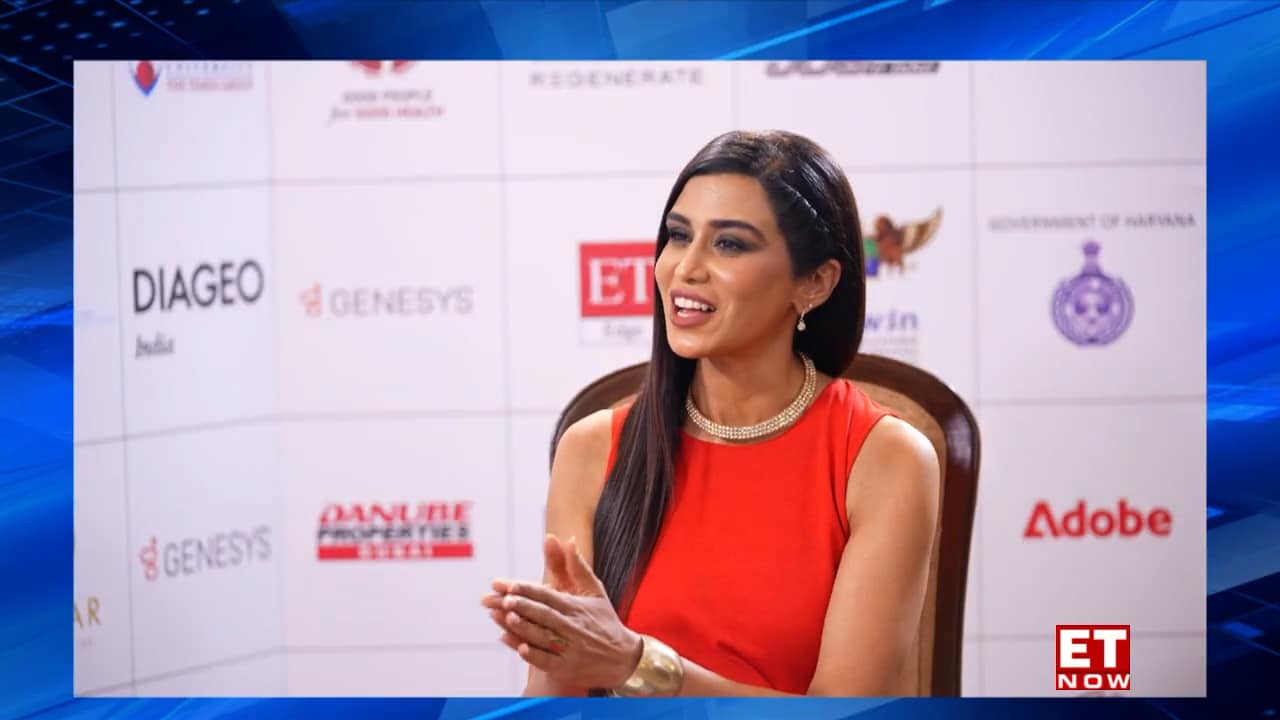 Pooja Jain in a broadcast media studio anchoring the news