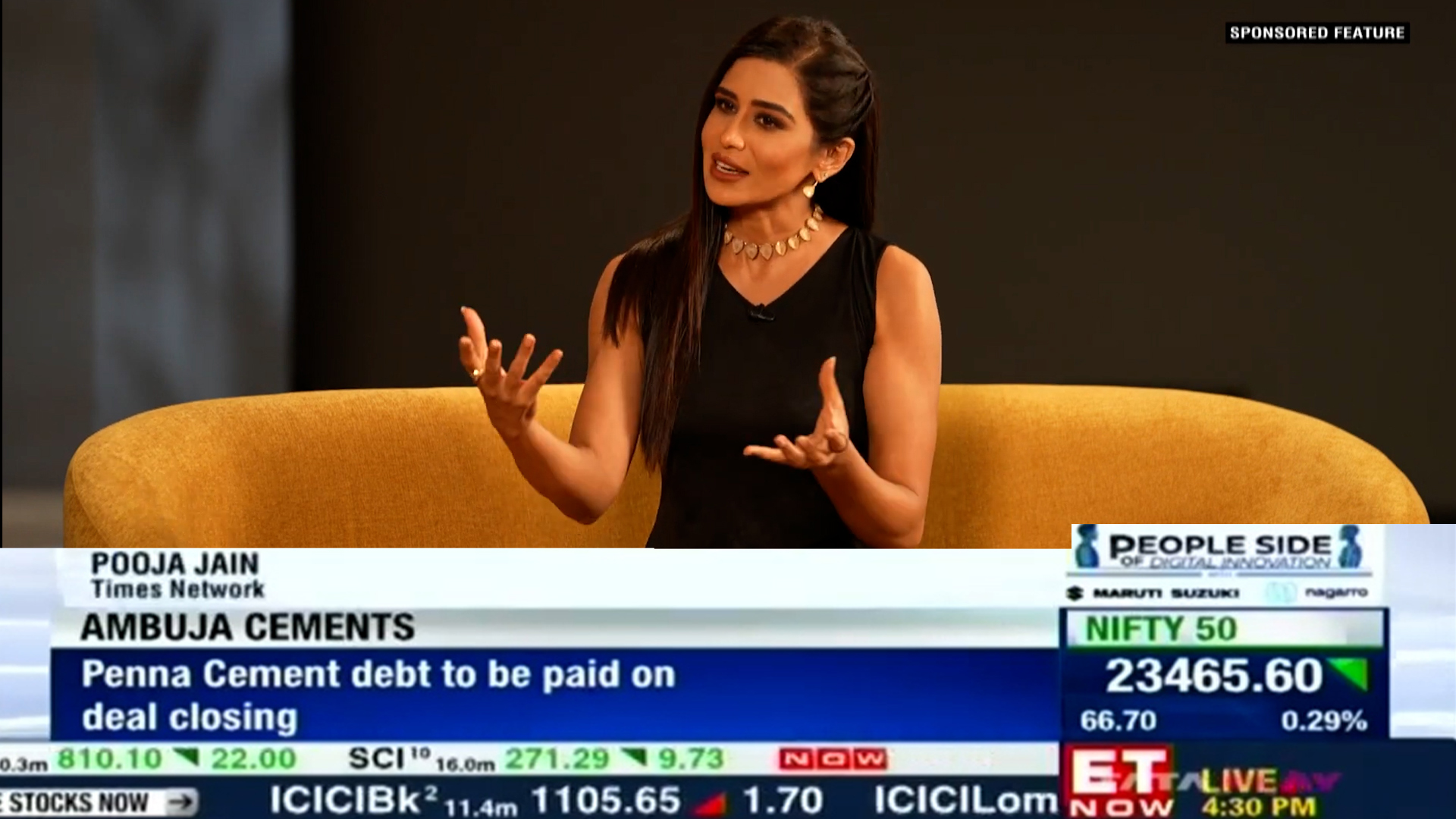 Pooja Jain in a broadcast media studio anchoring the news